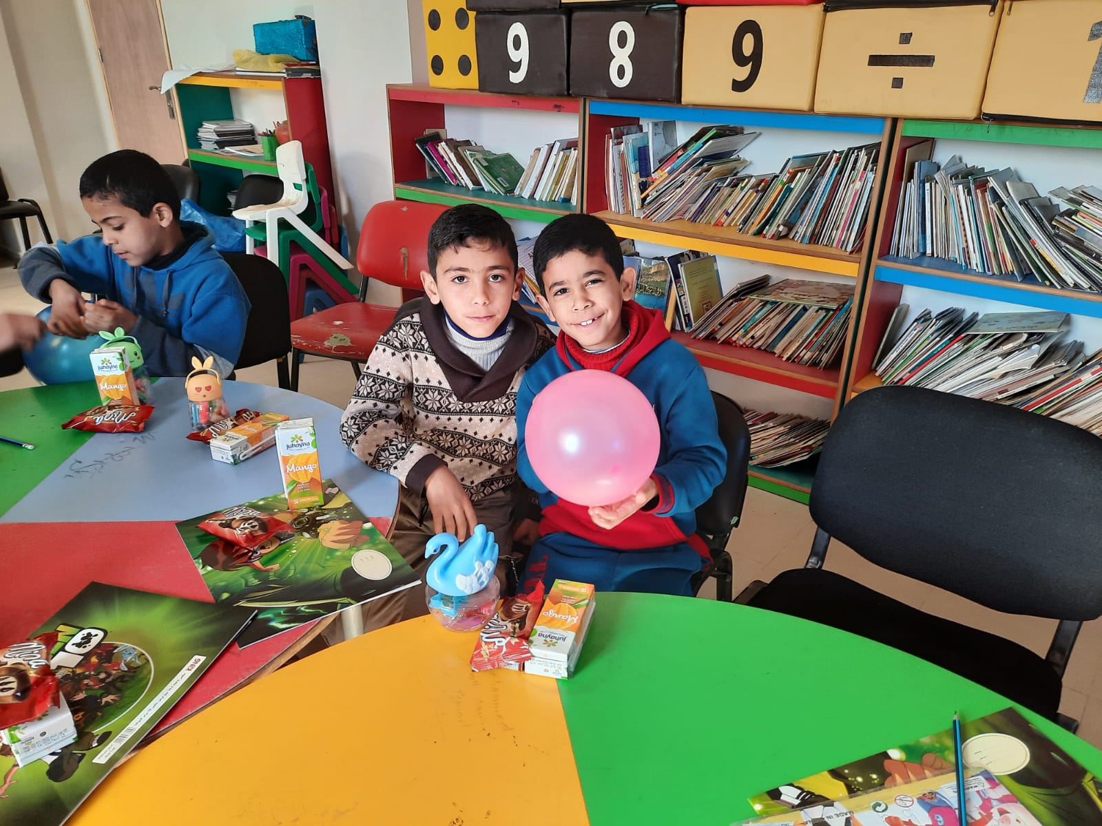photo showing children in a day-care setting with games and balloons